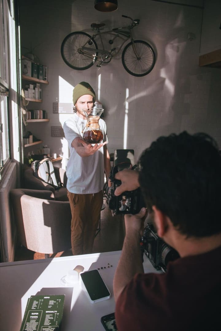 Photographer shooting a portrait in a cafe